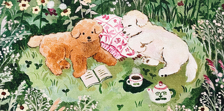 Two fluffy dogs are in a garden. One tan, one white. They relax on a floral blanket with a book, tea set, and flowers around them. The scene is serene and charming.