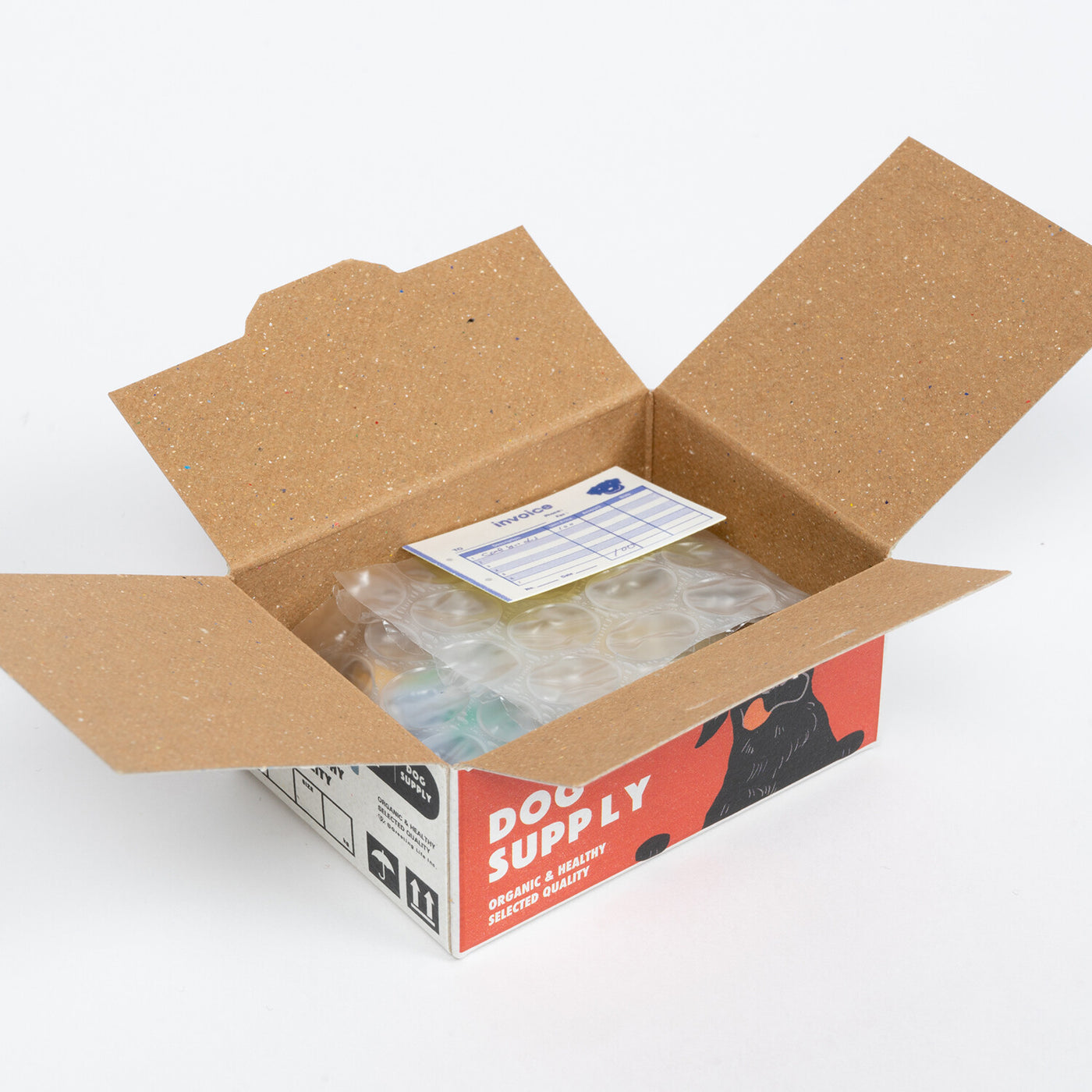 An open "Japanese Mini Sticker Box Dog Supply" by Blue Dog Posters shows items wrapped in bubble wrap with a small packing slip on top, all set against a plain white background.