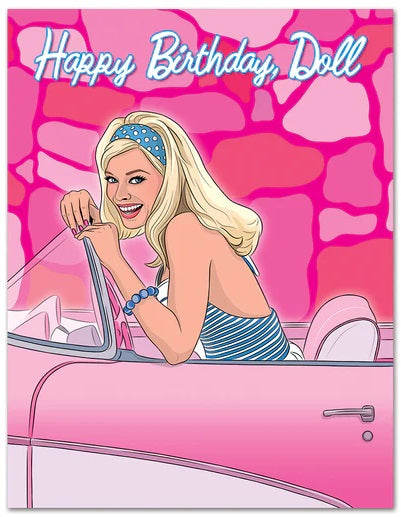 Illustration of a smiling woman with long blonde hair, wearing a blue headband and a striped top, sitting in a pink convertible car. The background features pink tones with irregular shapes. At the top, "Happy Birthday, Doll" is written in a playful blue font. This delightful scene is featured on the Barbie Doll Happy Birthday Card by Blue Dog Posters.