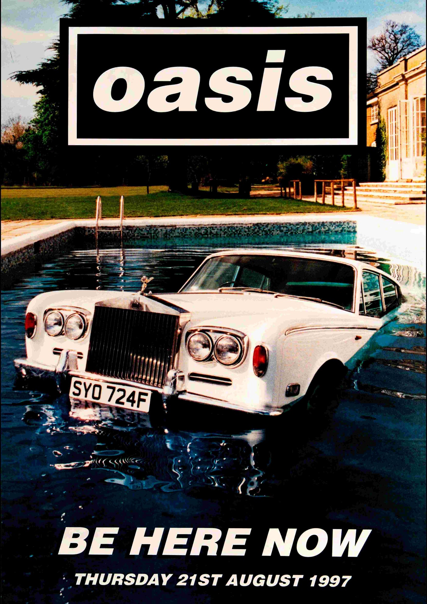 A classic white Rolls-Royce submerged in a pool beside a mansion with trees in the background, featuring the band name "Oasis" and the text "Be Here Now, Thursday 21st August 1997", is captured on Blue Dog Posters' product "Oasis - Be Here Now".