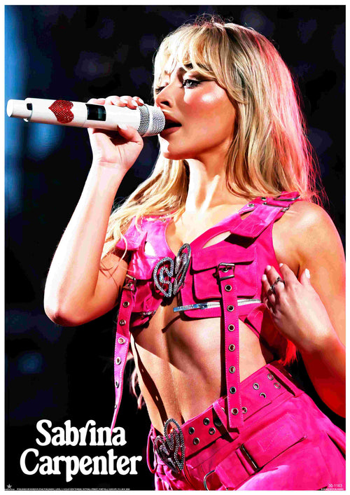 Sabrina Carpenter performs on stage in a pink outfit with heart buckles, holding a white mic with red hearts. This vibrant A3 poster, "Sabrina Carpenter Pink" by Blue Dog Posters, is printed on premium 250gsm Satin Paper. Her name appears below in bold white letters.