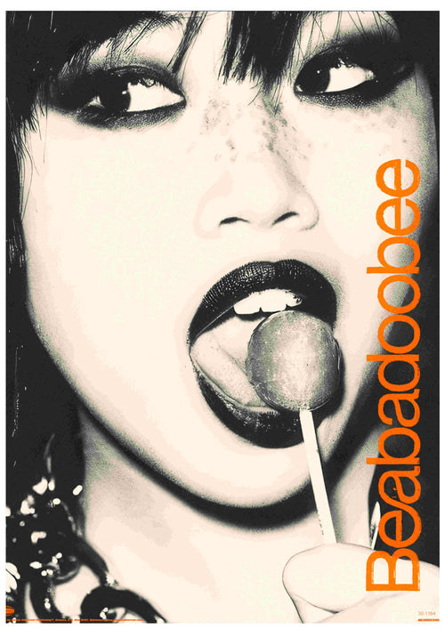 Black-and-white close-up of a person with bold makeup holding a lollipop near their mouth. "Beabadoobee" in bold orange letters on the right. A striking A3 music poster by Blue Dog Posters, printed on satin paper.