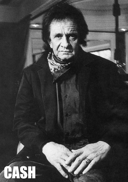 Black and white photo of an older man with a serious expression, wearing a dark jacket and a bandana around his neck. He is sitting with his hands resting on his lap. The word "Johnny Cash" is in bold letters at the bottom left corner, ideal for any Music Collection Poster printed on premium gloss paper by MUS 277.