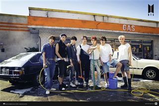 In front of a gas station, a group of seven young men from BTS stand together, with two cars parked nearby. They appear to be washing the cars, equipped with car washing supplies like hoses and buckets. Casually dressed and radiating a sunny, retro vibe, this scene is perfectly captured on MUS 280's premium 150gsm gloss paper K-Pop poster titled "BTS - Gas Station.