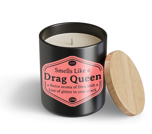 The Drag Queen Candle Hustle & Co by Blue Dog Posters is a black jar with a wooden lid and a pink label that reads: "Smells Like a Drag Queen—a fierce aroma of Diva with a hint of glitter in your crack.