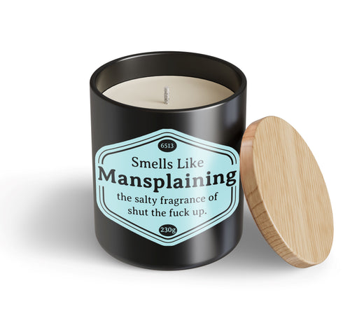 The unused Mansplaining Candle Hustle & Co by Blue Dog Posters features a black jar with a wooden lid and a pale blue label that reads: "Smells Like Mansplaining—the salty fragrance of shut the fuck up.