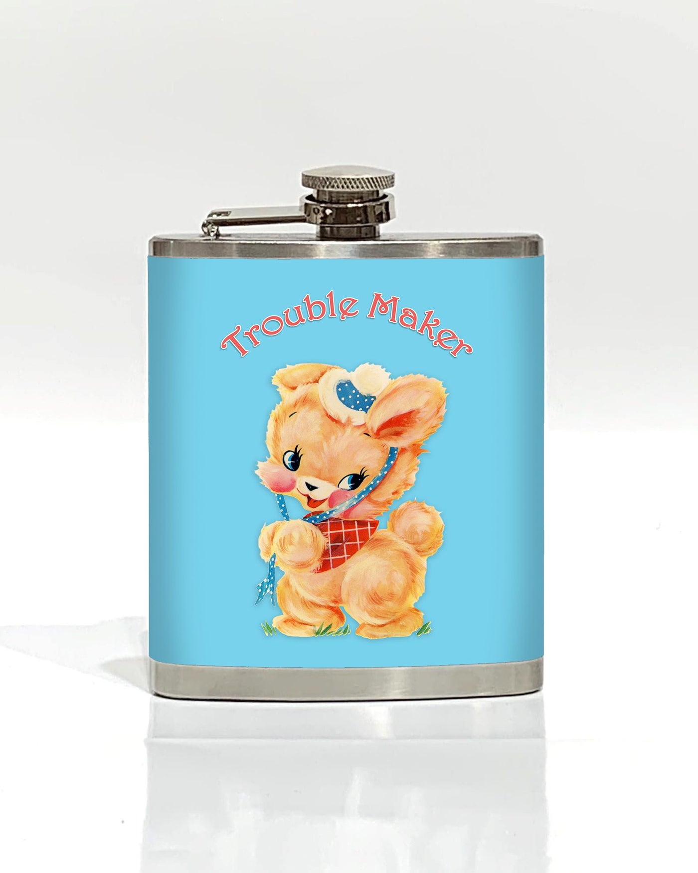 The Trouble Maker Hip Flask by Blue Dog Posters is a stainless steel flask adorned with a light blue label. The label features a vintage-style illustration of an adorable, anthropomorphic bunny dressed in a red checkered bib and a polka-dot bonnet. Above the bunny, "Trouble Maker" is written in a playful font, making it one of the coolest gifts around.