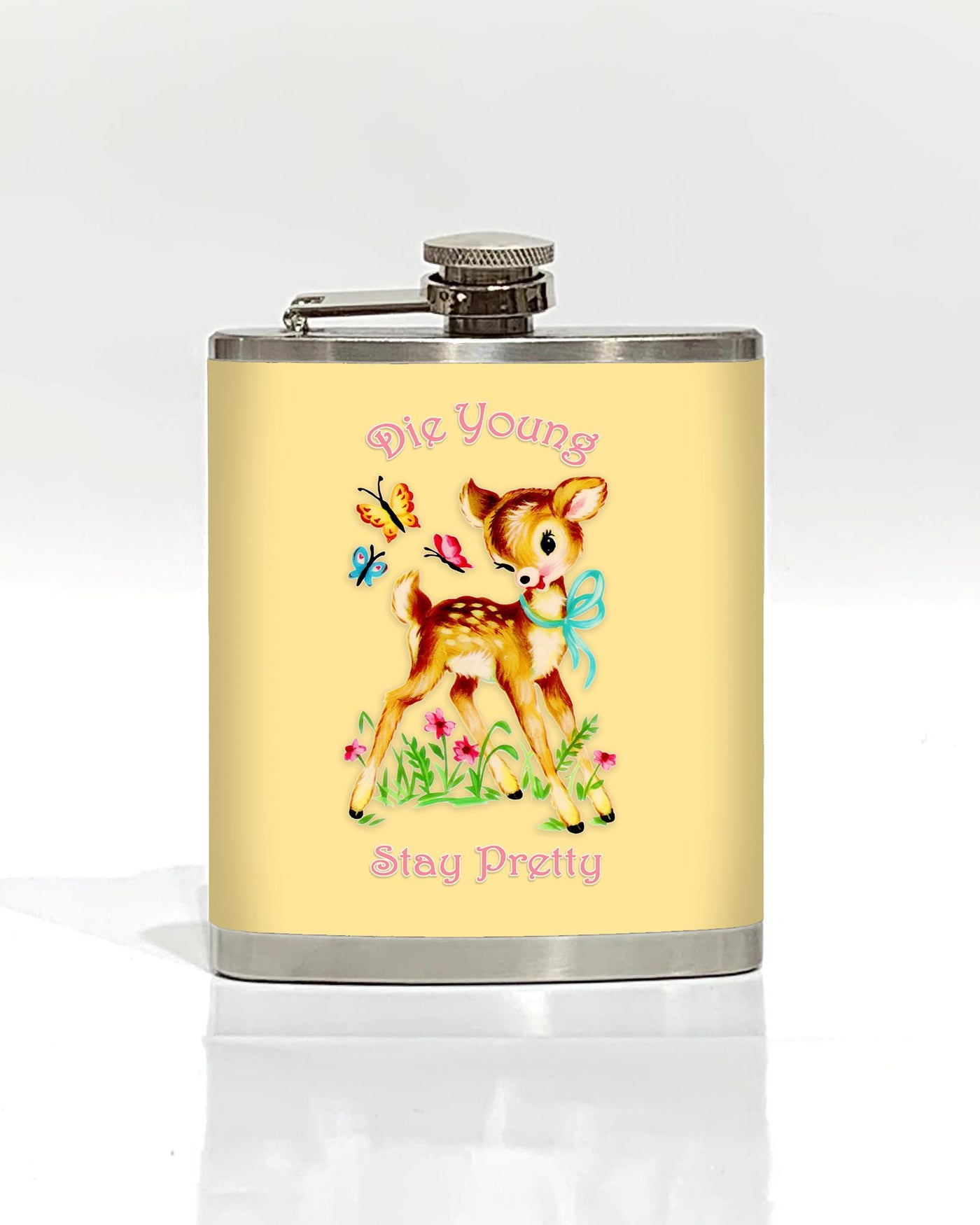 The Die Young Stay Pretty Hip Flask by Blue Dog Posters features a stainless steel design with a yellow background, depicting an adorable cartoon fawn adorned with a blue bow around its neck, surrounded by flowers and butterflies. The whimsical yet edgy text "Die Young" is displayed above the fawn, while "Stay Pretty" is written below. As part of our Cool Gifts Collection, this hip flask offers a charmingly bold accessory for any occasion.