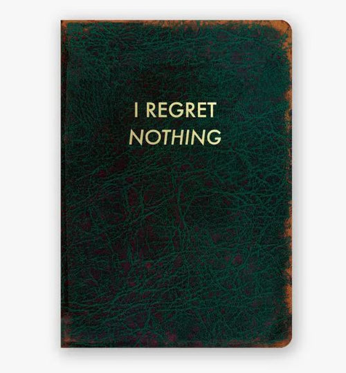 The **I Regret Nothing Journal** from **Blue Dog Posters** is a dark green, leather-bound notebook featuring "I REGRET NOTHING" emblazoned in gold foil-stamped letters on the cover. Its textured, worn appearance and slightly frayed edges enhance its charm, while the ruled pages inside help keep your thoughts organized.