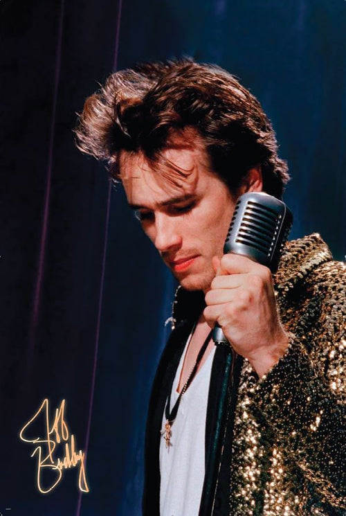 A man with tousled hair in a sequin jacket holds a vintage microphone, looking down thoughtfully against a dark, blurred background. "MUS 040 Jeff Buckley - Mic" appears in gold as a stylized signature in the bottom left corner.