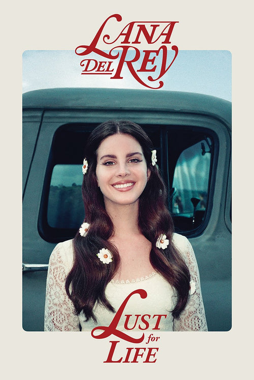 A woman with long dark hair adorned with white flowers is smiling in front of a vintage green truck. She is wearing a white lace dress. The stylish text "Lana Del Rey" and "Lust For Life" are written in red at the top and bottom of the MUS 122 Lana Del Rey Lust For Life Alternative Music Poster, making it a perfect addition to your music collection.