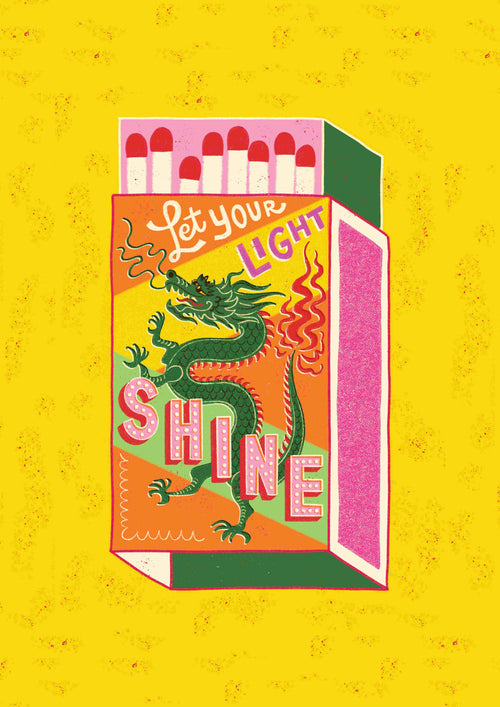 Illustration of a colorful matchbox from Blue Dog Posters featuring a dragon design, containing red-tipped matches. The text on the matchbox reads, "Let Your Light Shine by Miriam Giudici." The background is bright yellow with a textured pattern.