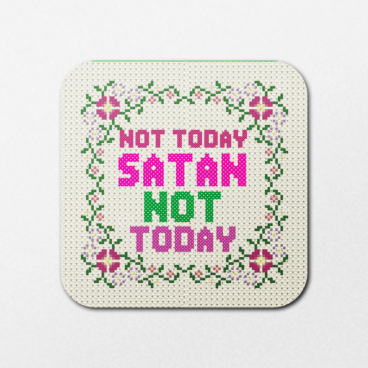 The "Not Today Satan Coaster" by Blue Dog Posters features a cross-stitched design with floral borders and the words "Not Today Satan Not Today" in bright pink and green letters on a square canvas.