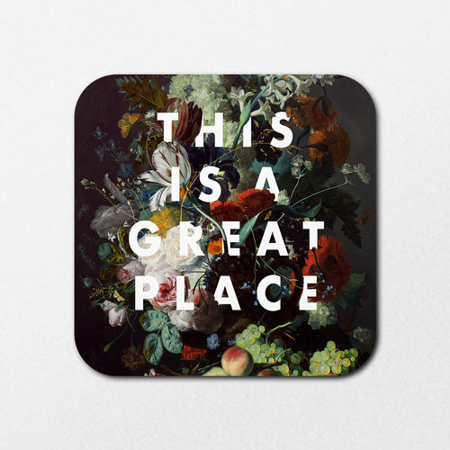 The Great Place Coaster by Blue Dog Posters features vibrant roses, blossoms, and fruit on a floral background with the bold text "THIS IS A GREAT PLACE" in large white letters.