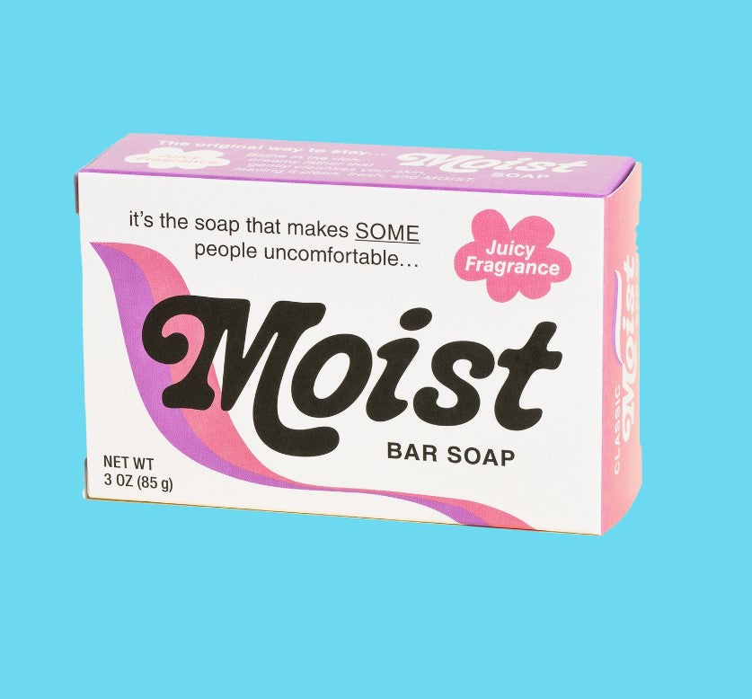 A bar of soap in its packaging, labeled "Moist Triple Milled Boxed Bar Soap" with an additional label "Juicy Fragrance." The packaging humorously states, "it's the soap that makes SOME people uncomfortable..." Proudly Vermont-made by Blue Dog Posters. The light blue background highlights its 3 oz (85 g) size.