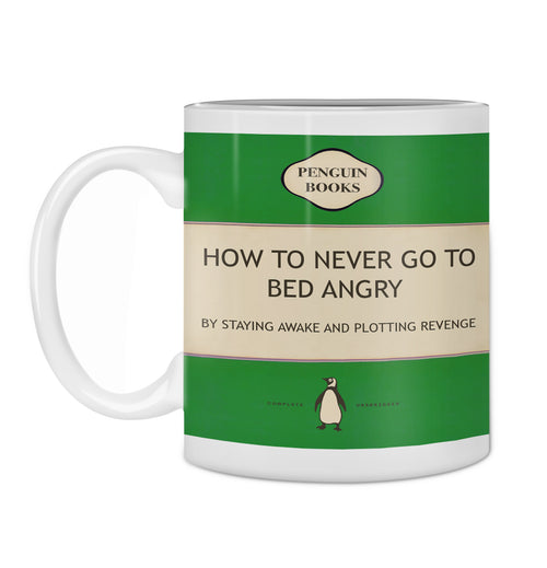 The Hustle & Co Book Mug - Go To Bed Angry by Blue Dog Posters is a white coffee mug featuring a green book cover design reminiscent of Penguin Books. The text reads, "HOW TO NEVER GO TO BED ANGRY: BY STAYING AWAKE AND PLOTTING REVENGE," with an illustration of a penguin below the text. Plus, it's dishwasher safe!