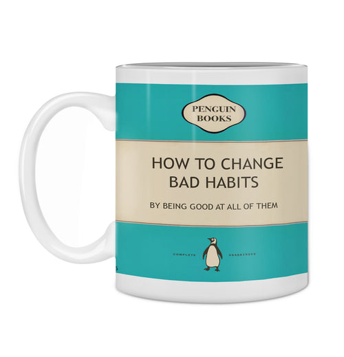 The Hustle & Co Book Mug - Change Bad Habits by Blue Dog Posters is designed to resemble a classic Penguin Books cover. The mug features the title "How to Change Bad Habits" and a humorous subtitle, "By Being Good at All of Them." It sports a predominantly teal and beige color scheme with a small penguin logo at the bottom. Part of the Homewares Collection, this mug is also dishwasher safe for easy cleaning.