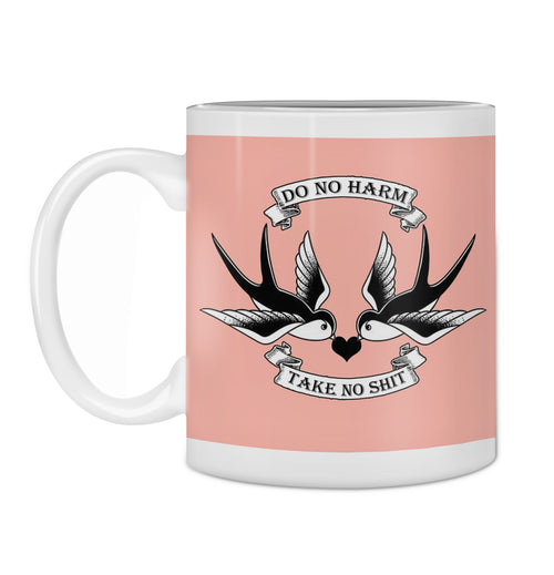 The Hustle and Co Mug - Do No Harm by Blue Dog Posters is a white ceramic mug set against a pink background, featuring two black and white swallows facing each other. A banner above the birds reads "DO NO HARM," while another below them states "TAKE NO SHIT." This mug is the perfect addition to your kitchen collection.