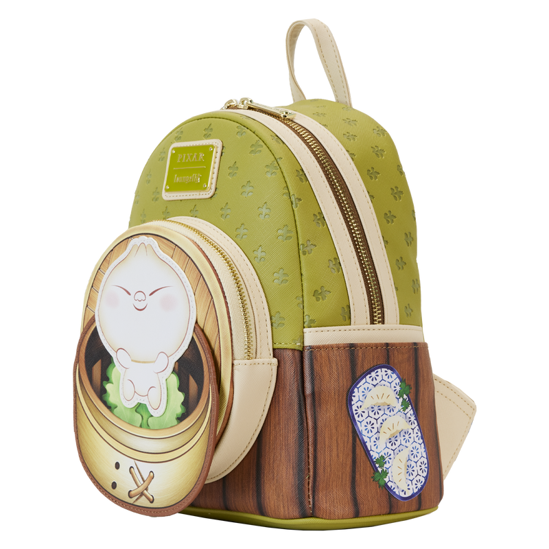 The Bao Bamboo Steamer Mini Backpack by Blue Dog Posters is a small green and brown Vegan Leather Backpack that features a dumpling character in a bamboo steamer design on the front pocket, complete with light beige straps and zippers. Additionally, it includes a blue and white floral-patterned sticker on the lower right side.