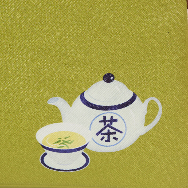 Illustration of a white teapot with a matching teacup on a green background. The teapot, complete with a lid and spout, and the tea-filled teacup are both decorated with blue Chinese characters that evoke the design seen in the Blue Dog Posters' Bao Bamboo Steamer Mini Backpack collection.
