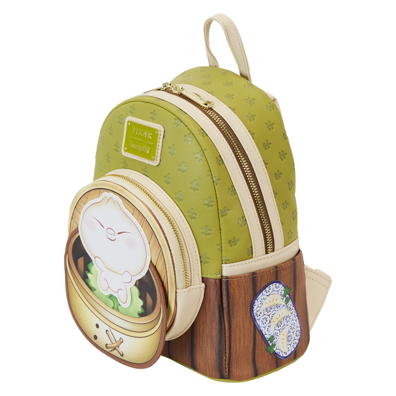 Introducing the Bao Bamboo Steamer Mini Backpack from Blue Dog Posters: a charming green and cream accessory crafted from vegan leather with a textured bamboo pattern and wooden accents. It features a front pocket adorned with an adorable cartoon dumpling character inspired by Disney-Pixar's Bao, complemented by a blue-patterned patch beside it.