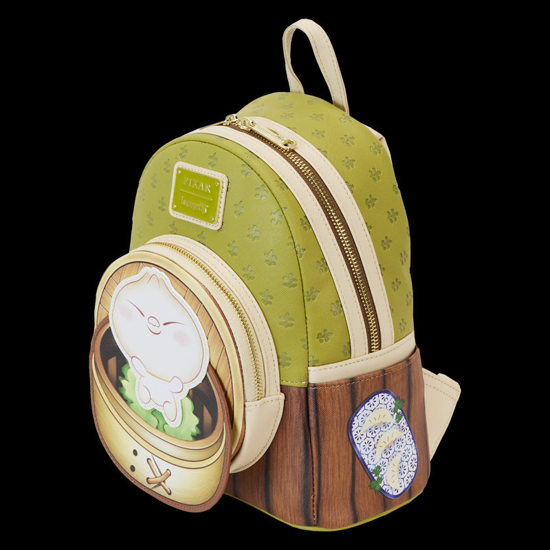 Introducing the Bao Bamboo Steamer Mini Backpack from Blue Dog Posters: a charming green and cream accessory crafted from vegan leather with a textured bamboo pattern and wooden accents. It features a front pocket adorned with an adorable cartoon dumpling character inspired by Disney-Pixar's Bao, complemented by a blue-patterned patch beside it.
