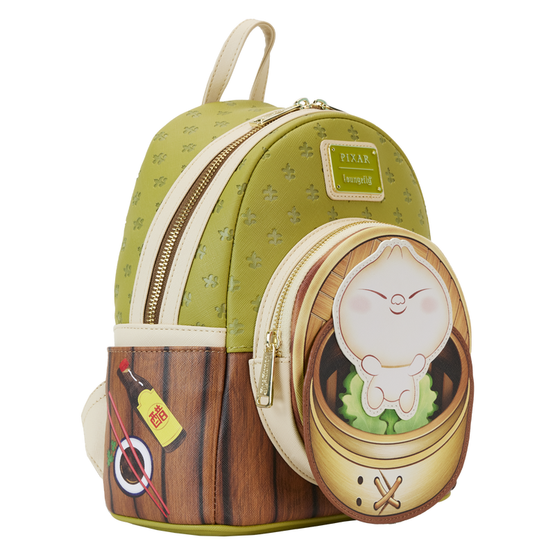 Introducing the Bao Bamboo Steamer Mini Backpack by Blue Dog Posters: a compact green backpack crafted from vegan leather, featuring an embossed pattern. This delightful Disney-Pixar Bao design includes a side pocket illustrated with soy sauce and a main front pocket showcasing an adorable dumpling character inside a bamboo steamer. The backpack is completed with elegant gold zippers.