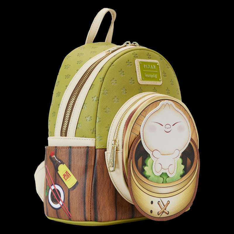 Introducing the Bao Bamboo Steamer Mini Backpack by Blue Dog Posters: a compact green backpack crafted from vegan leather, featuring an embossed pattern. This delightful Disney-Pixar Bao design includes a side pocket illustrated with soy sauce and a main front pocket showcasing an adorable dumpling character inside a bamboo steamer. The backpack is completed with elegant gold zippers.