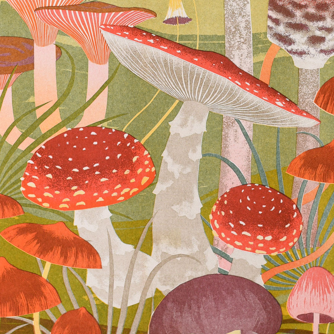 The Fungi Riso Print by Printer Johnson, offered by Blue Dog Posters, showcases a whimsical illustration of various red and white mushrooms with speckled caps. This unique risograph print features a vibrant natural scene set against green foliage and is crafted using eco-friendly inks.
