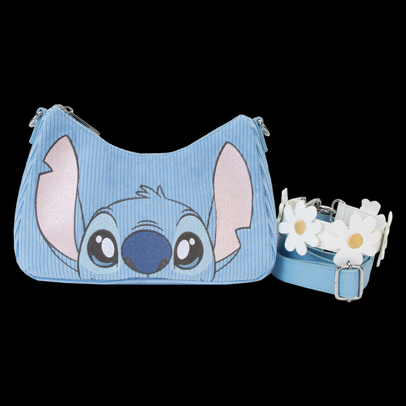 The Lilo & Stitch Springtime Daisy Crossbody by Blue Dog Posters is a blue shoulder bag adorned with a cartoon face resembling Stitch on the front. This Disney product features a detachable strap decorated with white daisy flowers and is crafted from premium vegan leather, making it both stylish and environmentally friendly.