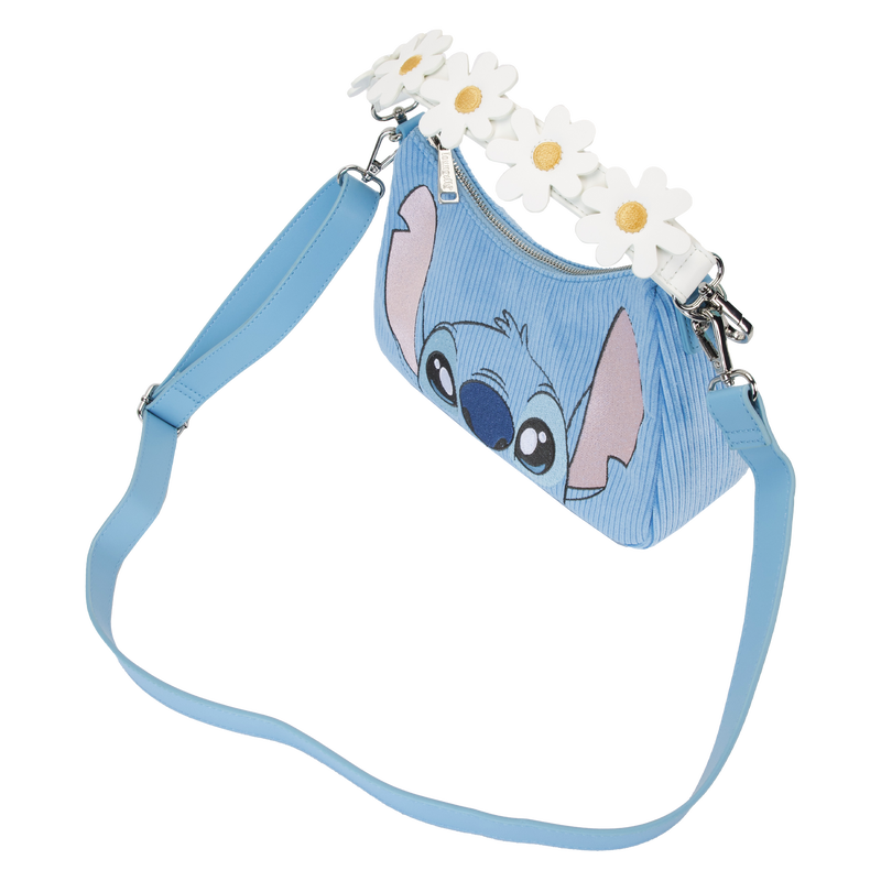 Introducing the Lilo & Stitch Springtime Daisy Crossbody from Blue Dog Posters – a light blue crossbody bag showcasing a smiling animated character on the front and adorned with white daisy flowers along the top edge. This Disney product features a matching blue adjustable shoulder strap, silver-tone hardware, and is crafted from vegan leather.