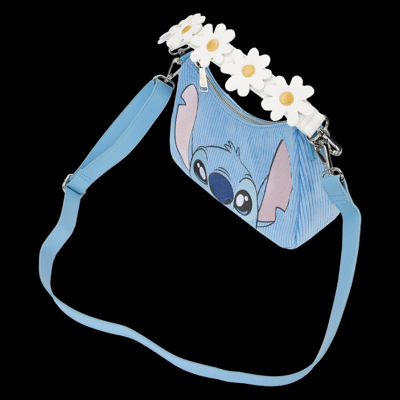 Introducing the Lilo & Stitch Springtime Daisy Crossbody from Blue Dog Posters – a light blue crossbody bag showcasing a smiling animated character on the front and adorned with white daisy flowers along the top edge. This Disney product features a matching blue adjustable shoulder strap, silver-tone hardware, and is crafted from vegan leather.