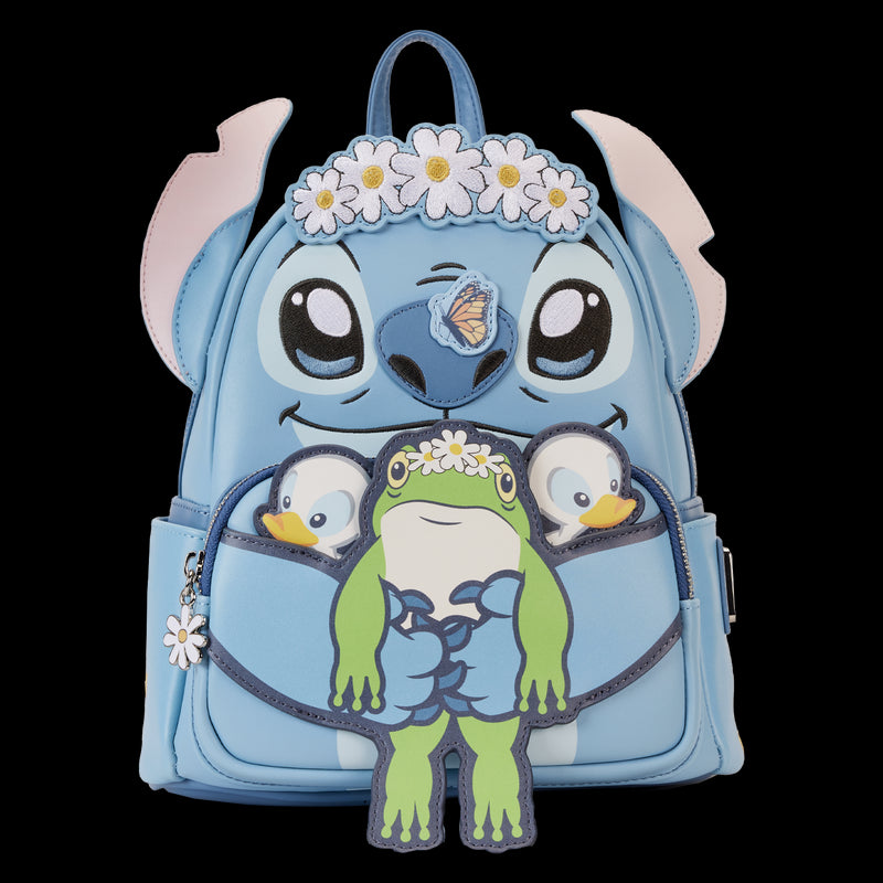 The Lilo & Stitch Springtime Mini Backpack by Blue Dog Posters is a blue vegan leather backpack featuring a large, playful face with big eyes and a daisy flower crown. This charming mini backpack includes pink ears and multiple attached accessories including a frog, two small duck characters, and a butterfly on the nose.