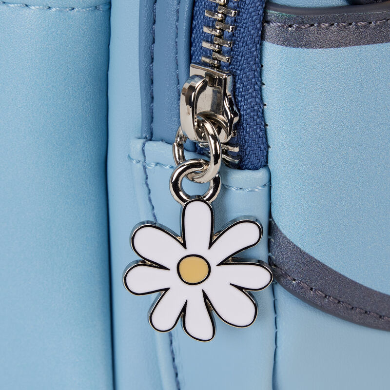 Close-up image of the Lilo & Stitch Springtime Mini Backpack from Blue Dog Posters, featuring a zipper with a white daisy charm. The charm has a circular yellow center and white petals, adding a decorative touch to the light blue Vegan Leather bag. The metallic zipper is partially open, revealing blue and dark grey details inside.