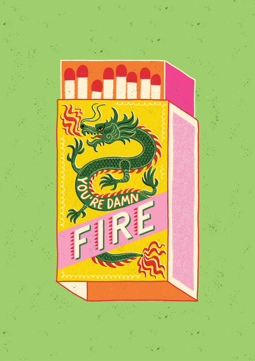 An illustration of a matchbox against a green background, prominently featuring a green dragon with red accents. The text on the matchbox reads "You Are Damn Fire by Miriam Giudici" and you can see red-tipped matches inside. The design is colorful, has a retro-inspired style, and boasts bold elements, brought to you by Blue Dog Posters.