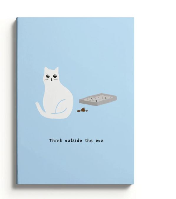 A Blue Dog Posters' A5 Soft Cover Notebook titled "Outside The Box" features a blue background with a white cat by a litter box and the playful caption "Think outside the box," encouraging creative thinking.