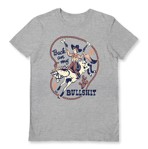 Blue Dog Posters' "Back on My Bullshit" Grey T-Shirt in medium boasts a vintage-inspired cowgirl design, complete with her riding a horse while holding a hat. The surrounding text, displayed in blue and red, declares "Back on my Bullshit," and is enclosed by a circular lasso border.