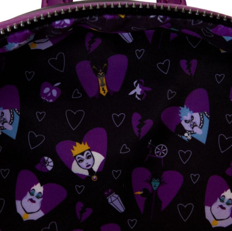 A close-up of the inside of the Disney Villains Curse Your Hearts Mini Backpack by Blue Dog Posters reveals a patterned lining with a dark purple background featuring various Disney Villains such as the Evil Queen, Ursula, and Maleficent. The design includes hearts and other themed icons scattered throughout, embracing the "Curse Your Hearts" motif.