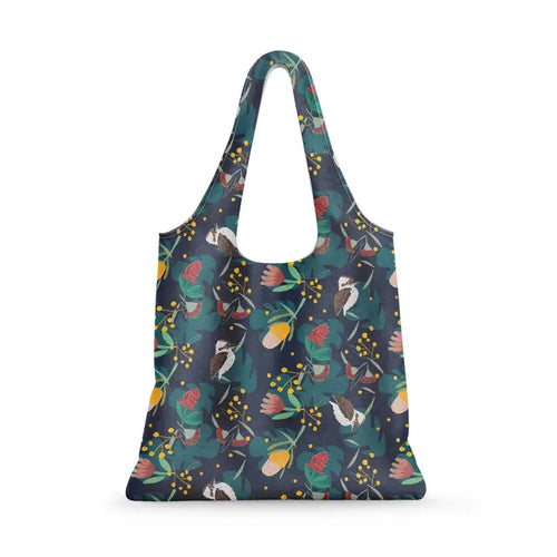 The Blue Dog Posters Floral Kookaburra Reusable Shopping Bag features a dark background with vibrant floral and bird designs. With wide handles, this eco-friendly tote combines style and sturdiness for carrying your items.