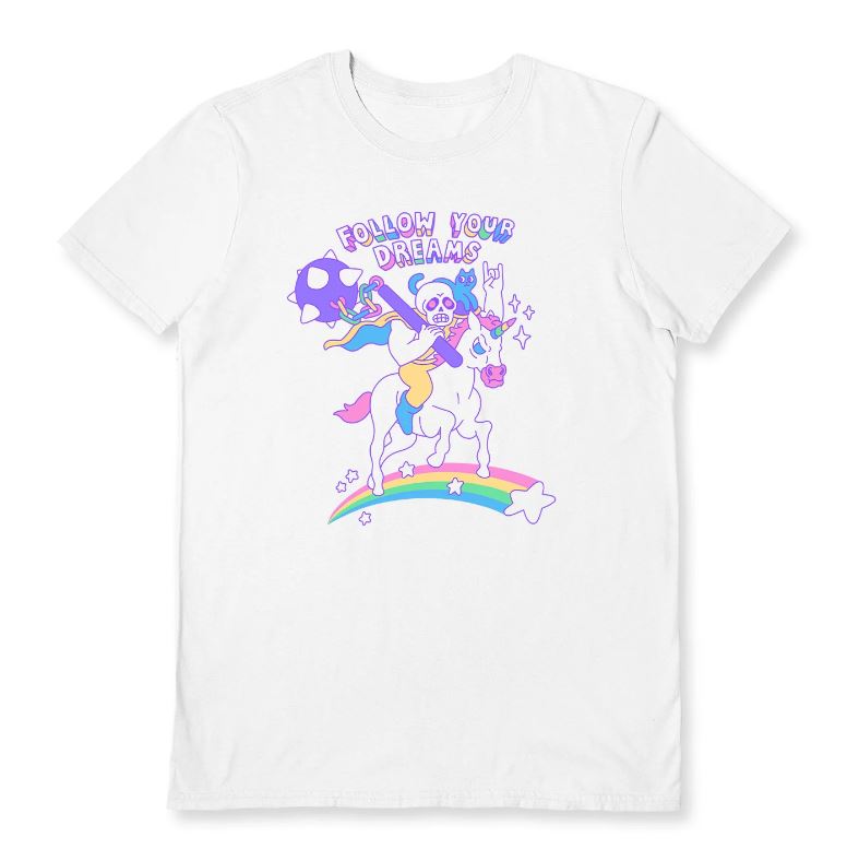 Unleash your inner dreamer with the "Follow Your Dreams White T-Shirt XL" by Blue Dog Posters. This white tee showcases a vibrant cartoon design of a skeleton wearing a cape, riding a unicorn over a rainbow adorned with stars. The playful font at the top reads "FOLLOW YOUR DREAMS," making it an inspiring addition to your wardrobe.