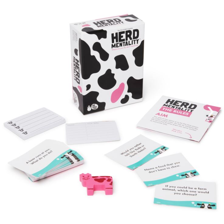 Image of the tabletop game "Herd Mentality Mini" by Blue Dog Posters. The family game box showcases cow print patterns and a pink cow icon. Displayed are playing cards with questions, answer pads, a rule booklet, and a small pink cow figure. The cards and items are spread out around the box, making it perfect for your next party game night.