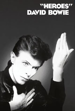 Black and white Music Poster of David Bowie posing for his "Heroes" album, featuring bold white text top right. Printed on premium 150gsm gloss paper. Product: David Bowie - Heroes by MUS 115.