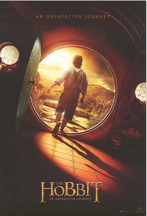A poster for "The Hobbit - An Unexpected Journey," produced by MTV, features a hobbit standing at the round door of a hobbit-hole. He gazes out at a sunlit landscape, suggesting the start of an adventure. The title is prominently displayed below the image.