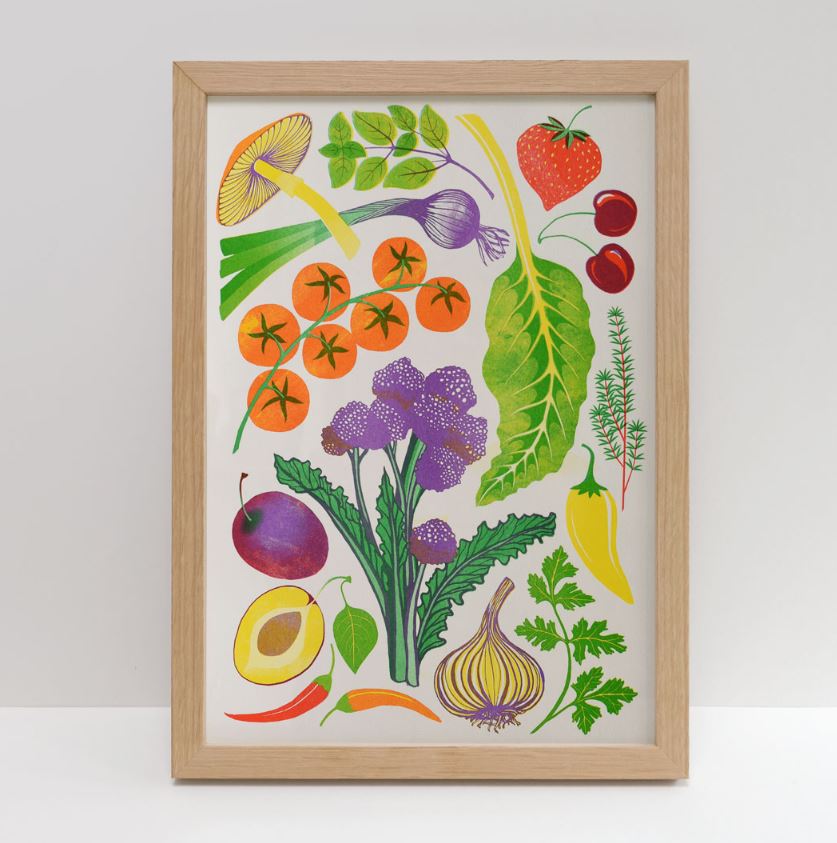 Home Grown Riso Print by Printer Johnson from Blue Dog Posters features a framed illustration of vibrant vegetables and fruits, such as mushrooms, strawberries, cherry tomatoes, garlic, leafy greens, cherries, plums, avocadoes, broccoli, onions, herbs, and chili peppers on a white background.