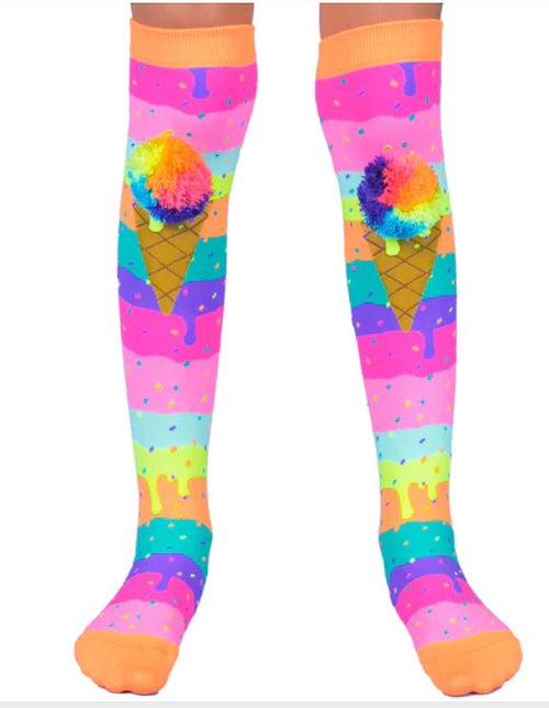 The Madmia Ice Cream Socks by Blue Dog Posters are knee-high and feature playful rainbow cone designs with pom-poms as scoops. They showcase a lively background of vibrant drips and dots in shades of pink, orange, green, blue, and purple. With orange toes and cuffs, these socks make a cheerful addition to any colorful ensemble.