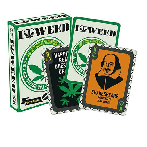 The "I Heart Weed Playing Cards" by Blue Dog Posters features a green and white deck box adorned with marijuana leaf graphics. Displayed are two unique cards: the 8 of hearts, decorated with marijuana leaves and the phrase "Happiness is... Reality does not exist," and the King of hearts card, which showcases an image of Shakespeare along with the text "Dabbled in Marijuana." This set is perfect for your next game of Go Fish or Snap.