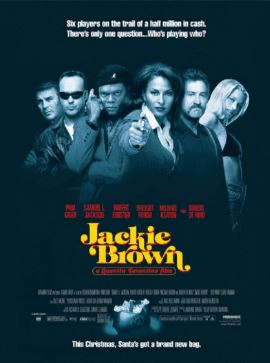 Introducing the Jackie Brown 30x40cm Mini Poster by Blue Dog Posters. This high-quality satin paper poster showcases an image from the movie "Jackie Brown," featuring six characters at the top, each with different expressions and clothing. The title "Jackie Brown" stands out in yellow text below them, with a tagline and additional credits on a blue background for added flair. Enjoy a sleek finish that brings this iconic movie to life on your wall.
