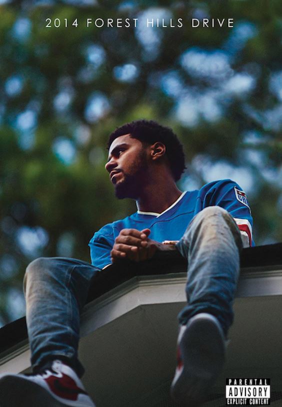 A person is sitting on a rooftop, gazing to the side. The image showcases a blurred background of trees. Text at the top reads "2019 Forest Hills Drive," with a "Parental Advisory" label in the bottom right corner, making it an ideal addition to any rap artist poster collection from MUS 139.