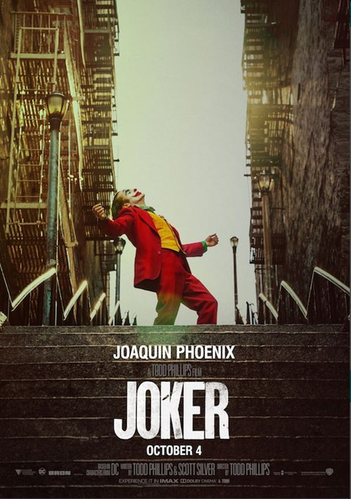 Movie poster for "Joker 2019" by MTV 099. A person in a red suit and face paint is dancing exuberantly on outdoor steps between tall buildings. Text at the bottom reads "Joaquin Phoenix in Joker," with a release date of October 4 and credits for Todd Phillips and Scott Silver. Hit movie posters like this are printed on premium gloss paper.