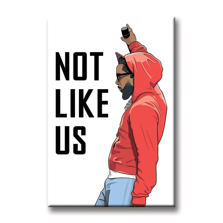 The Kendrick Not Like Us Magnet by Blue Dog Posters features an illustration of a man in a red hoodie, sunglasses, and cap raising one arm with a phone against a white background with bold black text reading “NOT LIKE US.”.